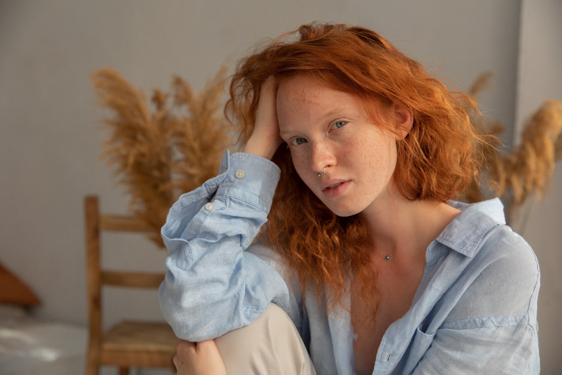 tranquil redhead woman touching hair