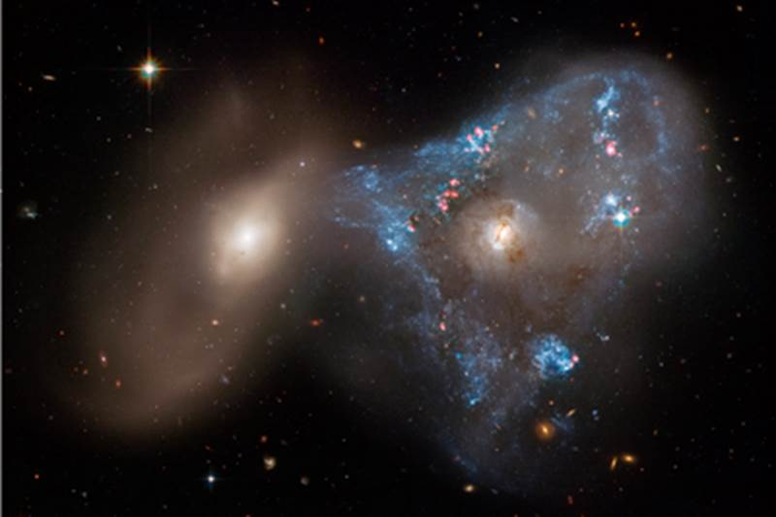 Galaxy collision creates ‘space triangle’ in new Hubble image.
