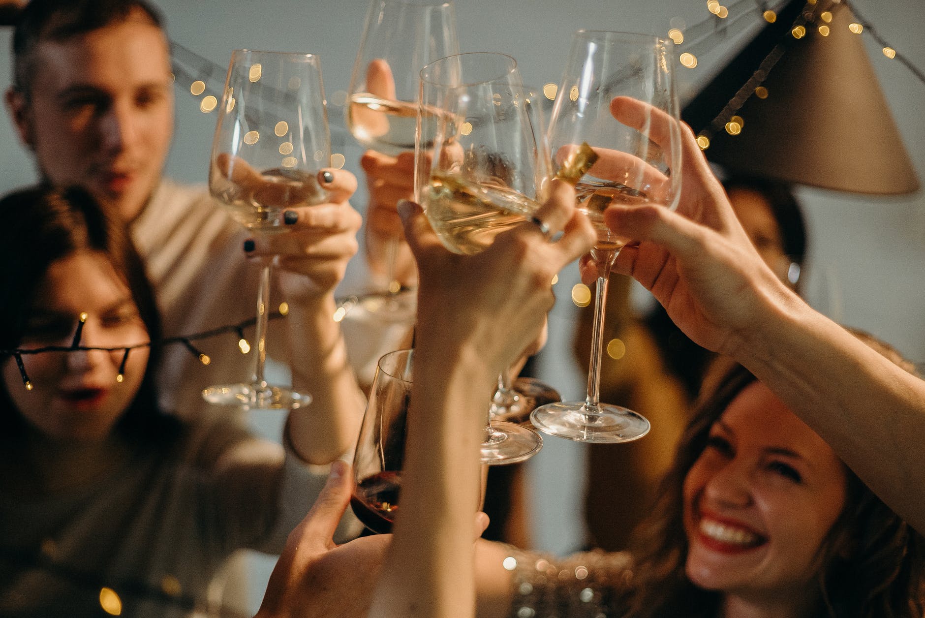 selective focus photography of several people cheering wine glasses